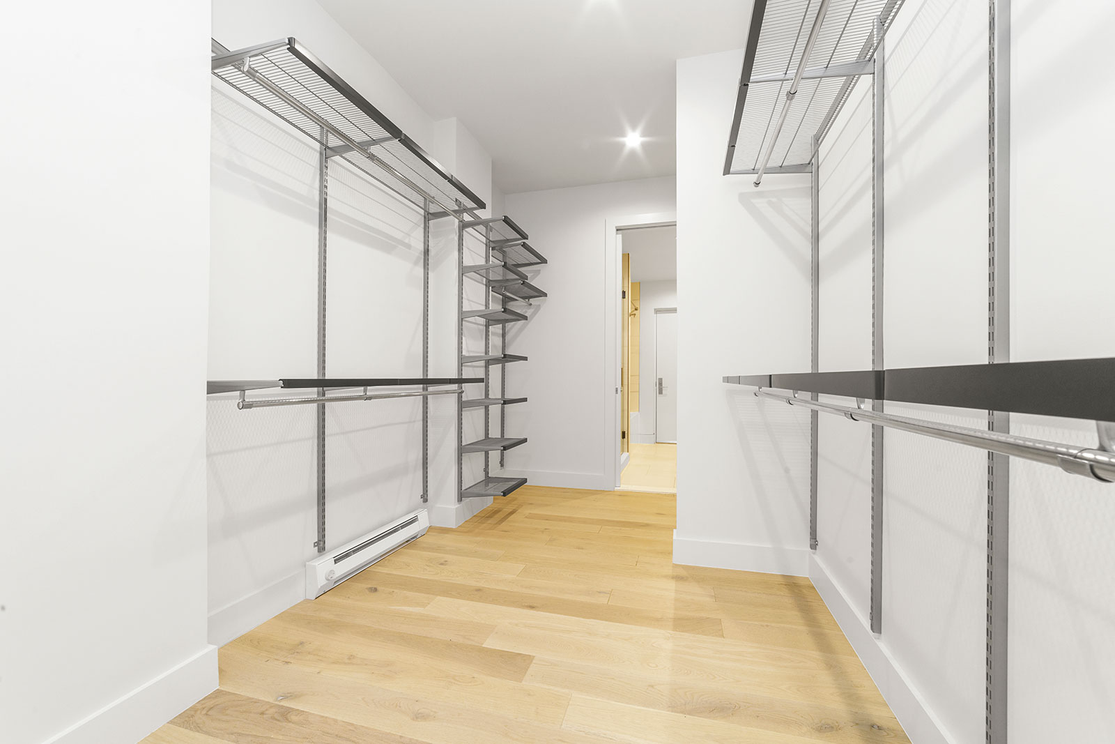 Apartments for Rent in Upper West Side Manhattan, NY - 125 Riverside - Closet with a Lot of Space, Light Wood-Style Flooring, White Walls, and Steel Hanging Rods and Shelves